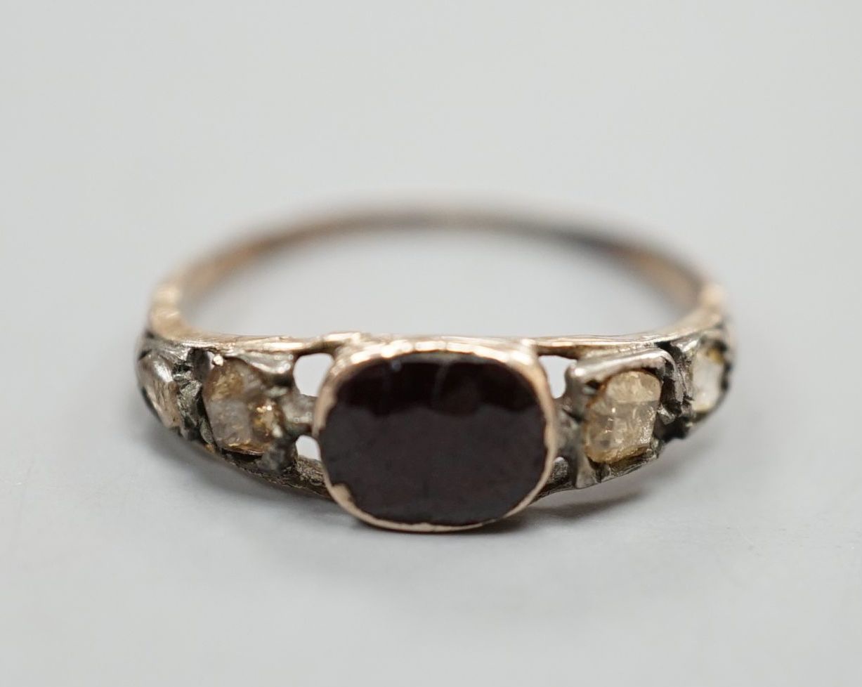 A 19th century yellow metal, garnet and diamond set five stone half hoop ring, size M, gross weight 1.7 grams.